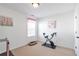 Empty room with an exercise bike, carpeted floors, and neutral paint at 3641 Devenwood Way, Buford, GA 30519