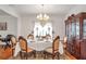 Formal dining room with chandelier, and china cabinet, perfect for holiday entertaining at 3641 Devenwood Way, Buford, GA 30519