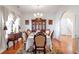 Elegant dining room with hardwood floors, a china cabinet, and natural light at 3641 Devenwood Way, Buford, GA 30519
