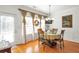 Dining room with a view of a window with bright natural light and a painting on the wall at 3641 Devenwood Way, Buford, GA 30519