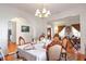 Formal dining room featuring hardwood floors, a chandelier, and an elegant table setting at 3641 Devenwood Way, Buford, GA 30519