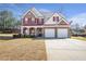Charming two-story home with red shutters, a covered porch, and a two-car garage at 3641 Devenwood Way, Buford, GA 30519