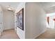 Hallway with neutral walls and carpet, decorative art, and access to multiple rooms at 3641 Devenwood Way, Buford, GA 30519
