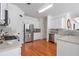 Large kitchen with stainless steel refrigerator, white cabinets and hardwood floors at 3641 Devenwood Way, Buford, GA 30519