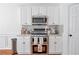 Updated kitchen featuring stainless steel appliances, white cabinets, and modern countertops at 3641 Devenwood Way, Buford, GA 30519