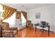 Cozy living room with hardwood floors, elegant curtains, and comfortable seating at 3641 Devenwood Way, Buford, GA 30519