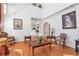 Hardwood floored living room with lots of natural light coming through large picture windows at 3641 Devenwood Way, Buford, GA 30519