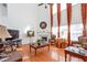 Bright living room featuring a fireplace, high ceilings, and large windows with elegant drapes at 3641 Devenwood Way, Buford, GA 30519