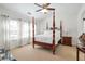 Spacious main bedroom with four poster bed, large windows and neutral carpet at 3641 Devenwood Way, Buford, GA 30519