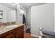 Bathroom featuring a granite vanity, with tile floors, updated fixtures, and plenty of counter space at 1291 Marcelle Heights Pl, Norcross, GA 30093