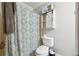 Cozy bathroom with decorative shower curtain, toilet, and white storage cabinet at 1291 Marcelle Heights Pl, Norcross, GA 30093