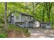 Two-story home with gray siding and a well-maintained yard surrounded by mature trees at 1291 Marcelle Heights Pl, Norcross, GA 30093