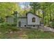 Two-story home with gray siding and a well-maintained front yard surrounded by mature trees at 1291 Marcelle Heights Pl, Norcross, GA 30093