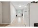 Hallway with neutral tile flooring, white walls, and a bright doorway at 1291 Marcelle Heights Pl, Norcross, GA 30093