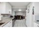 Kitchen view featuring white cabinetry, granite countertops, stainless appliances, and an adjacent dining area at 1291 Marcelle Heights Pl, Norcross, GA 30093