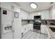 Bright kitchen with white cabinets, granite countertops, stainless steel appliances, and tile flooring at 1291 Marcelle Heights Pl, Norcross, GA 30093