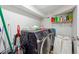 Well-equipped laundry area with washer, dryer, and storage shelf, maximizing space at 1291 Marcelle Heights Pl, Norcross, GA 30093