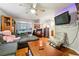 Comfortable living room with a ceiling fan, a large television, and couches at 1291 Marcelle Heights Pl, Norcross, GA 30093