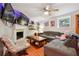 Comfortable living room with a fireplace, a ceiling fan, and a large television at 1291 Marcelle Heights Pl, Norcross, GA 30093