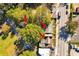 Aerial view shows the home surrounded by mature trees, offering shade and privacy near a road with commercial activity at 1640 Lakewood Se Ave, Atlanta, GA 30315