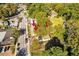 Overhead shot features a home enveloped by mature trees near a city street, offering a blend of nature and convenience at 1640 Lakewood Se Ave, Atlanta, GA 30315