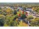 A picturesque aerial view of a home nestled amongst mature trees, adjacent to a well-maintained lawn and city street at 1640 Lakewood Se Ave, Atlanta, GA 30315