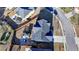 Drone shot of the backyard, featuring an outdoor dining area, play structure, and fence line at 2640 Paddock Point Pl, Dacula, GA 30019