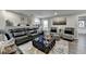 Finished basement showcasing a spacious seating area with a large sectional and plush ottoman at 2640 Paddock Point Pl, Dacula, GA 30019