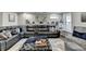 Finished basement showing a large sectional sofa, modern décor, and ample natural light at 2640 Paddock Point Pl, Dacula, GA 30019