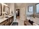 Well-lit bathroom with dual vanities, tiled floors, separate tub, and walk-in shower at 2640 Paddock Point Pl, Dacula, GA 30019