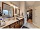 Bright bathroom with dual sinks, vanity, walk-in shower and access to the walk-in closet at 2640 Paddock Point Pl, Dacula, GA 30019