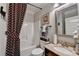 Cozy bathroom with tub, shower, decorative curtain, framed mirror, and granite countertop sink at 2640 Paddock Point Pl, Dacula, GA 30019