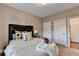 Inviting bedroom featuring a queen bed, soft bedding, decorative wall art, and ample closet space at 2640 Paddock Point Pl, Dacula, GA 30019