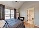 Bedroom with hardwood flooring, a large window, and an ensuite bathroom with a shower and white curtain at 2640 Paddock Point Pl, Dacula, GA 30019