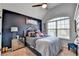 Bedroom featuring a large window with blinds and a bed with a gray velvet headboard and blue bedding at 2640 Paddock Point Pl, Dacula, GA 30019