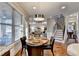 Bright breakfast nook with hardwood floors and natural light, adjacent to a staircase and living area at 2640 Paddock Point Pl, Dacula, GA 30019