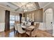 Elegant dining room with hardwood floors, coffered ceilings, neutral decor, and large window with natural light at 2640 Paddock Point Pl, Dacula, GA 30019