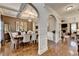 Inviting dining room with hardwood floors, coffered ceilings, and a view of the living area and kitchen at 2640 Paddock Point Pl, Dacula, GA 30019