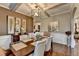 Elegant dining room featuring hardwood floors, wainscoting, neutral decor, and a stylish chandelier at 2640 Paddock Point Pl, Dacula, GA 30019