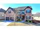 Charming two-story brick home featuring a two-car garage, manicured landscaping, and a welcoming entrance at 2640 Paddock Point Pl, Dacula, GA 30019