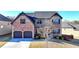 Charming two-story brick home featuring a two-car garage, manicured landscaping, and a welcoming entrance at 2640 Paddock Point Pl, Dacula, GA 30019