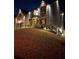 Nighttime shot of brick two-story home with garage and landscaped yard at 2640 Paddock Point Pl, Dacula, GA 30019