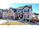 Charming two-story home featuring a brick facade, a well-manicured lawn, and a two-car garage, showcasing timeless elegance at 2640 Paddock Point Pl, Dacula, GA 30019