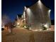 Nighttime exterior view of an illuminated two-story brick home with a manicured lawn at 2640 Paddock Point Pl, Dacula, GA 30019