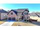 Charming two-story brick home featuring a two-car garage, manicured landscaping, and a welcoming entrance at 2640 Paddock Point Pl, Dacula, GA 30019