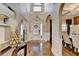 Elegant foyer with soaring ceilings, hardwood floors, and decorative details, leading into the home's dining area at 2640 Paddock Point Pl, Dacula, GA 30019