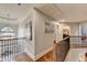 Well-lit upstairs hallway with hardwood floors, decorative art, and a view of the staircase below at 2640 Paddock Point Pl, Dacula, GA 30019