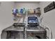 Modern laundry room with washer, dryer, shelving, and ironing board at 2640 Paddock Point Pl, Dacula, GA 30019