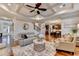 Open living room featuring hardwood floors, coffered ceiling, and comfortable furniture at 2640 Paddock Point Pl, Dacula, GA 30019