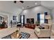 Spacious living room featuring vaulted ceilings, a large TV, and comfortable seating area at 2640 Paddock Point Pl, Dacula, GA 30019